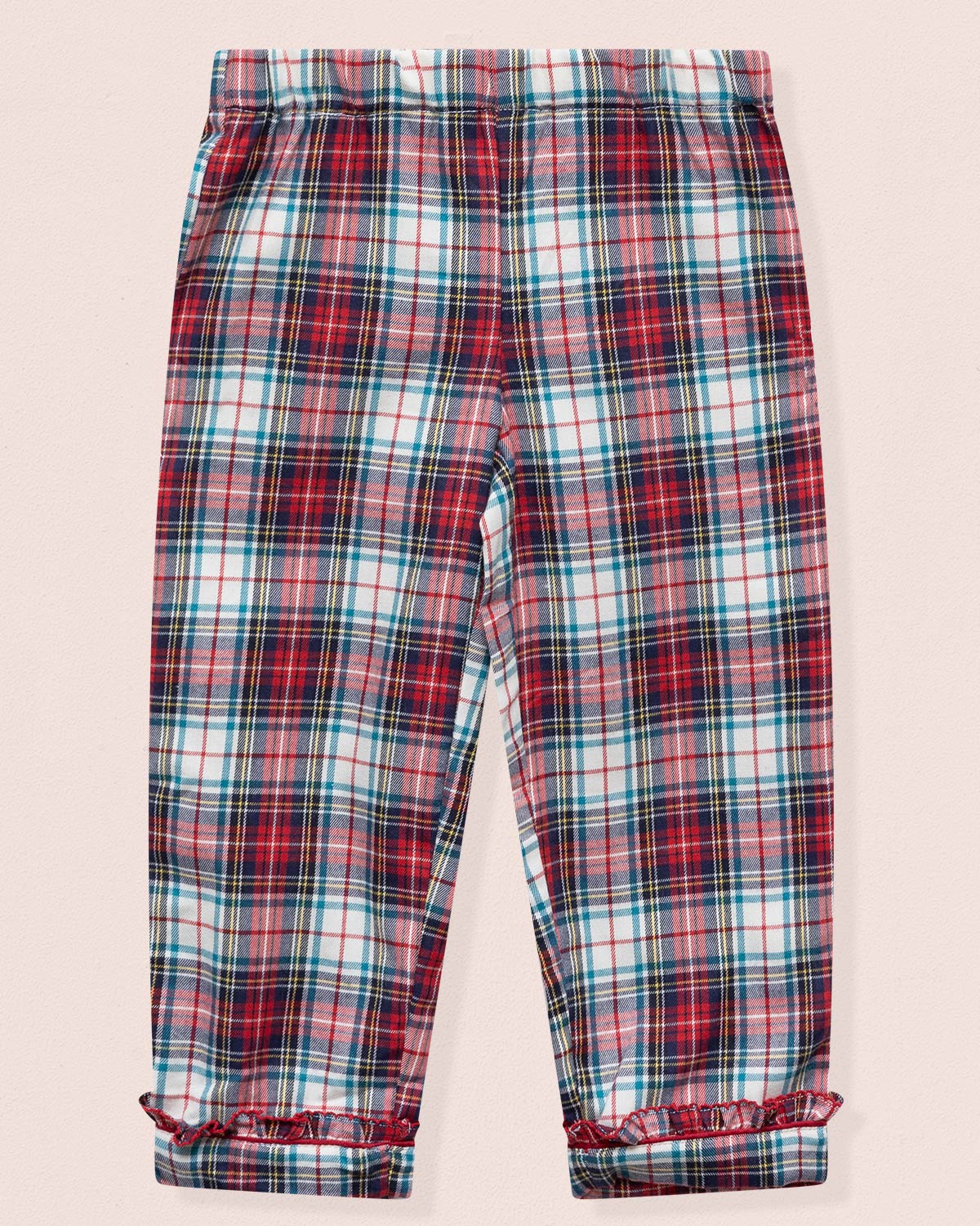 Plaid pants with red, blue, and white pattern on a light pink background