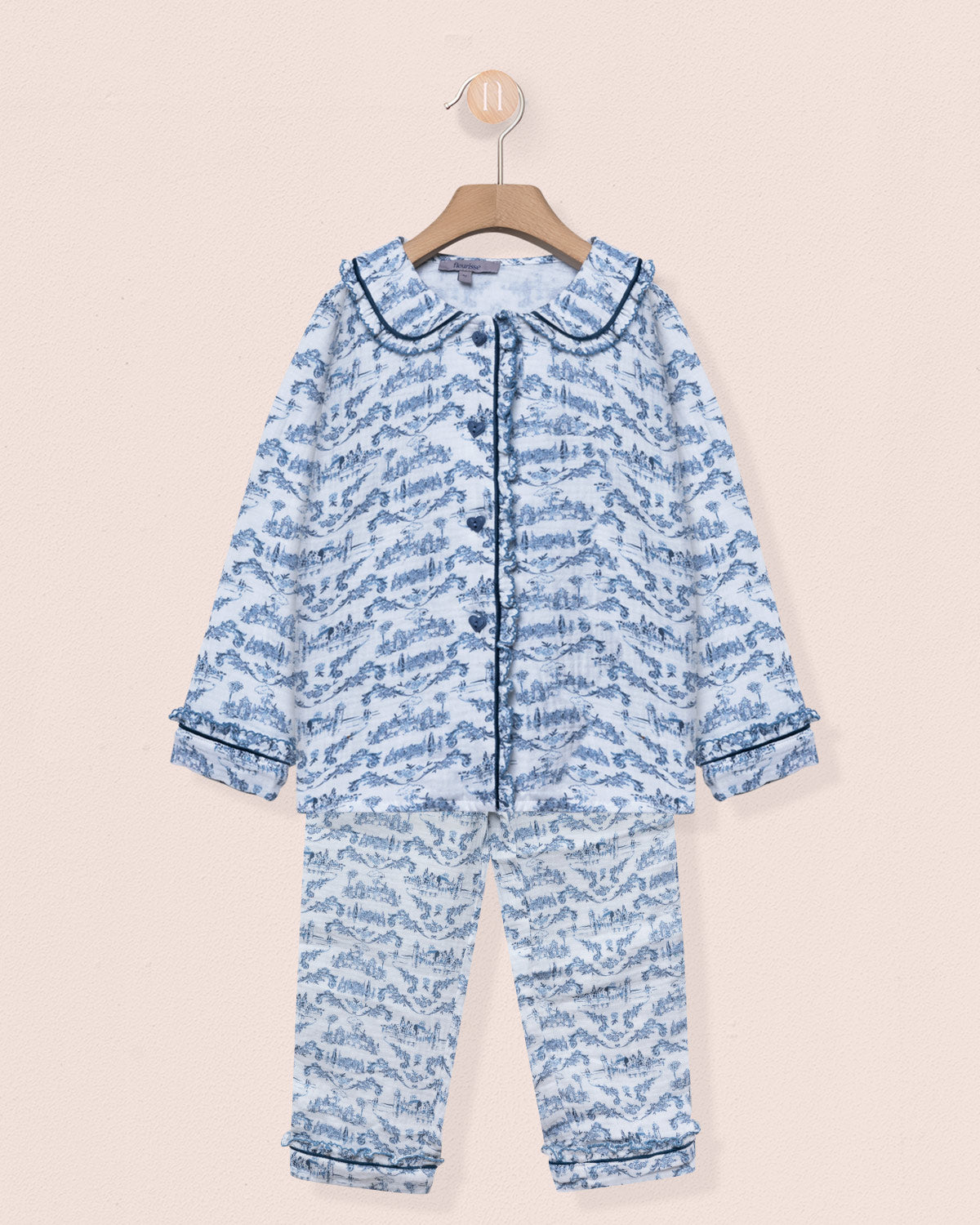 Blue patterned baby onesie on a beige background