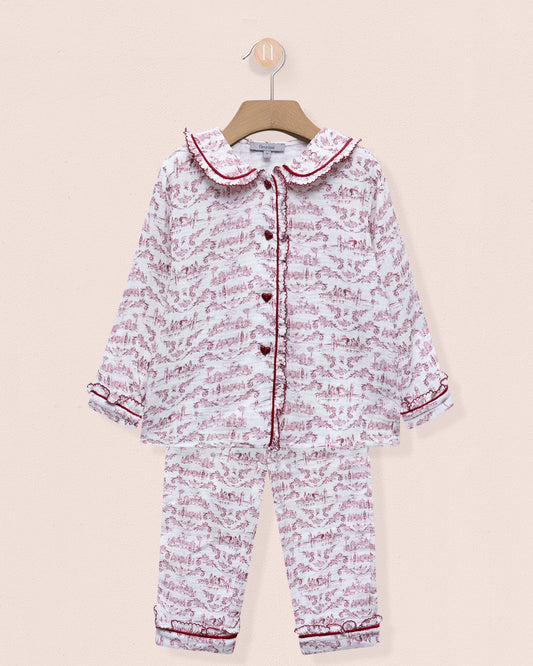 Children's pajama set with pink and white pattern on a beige background