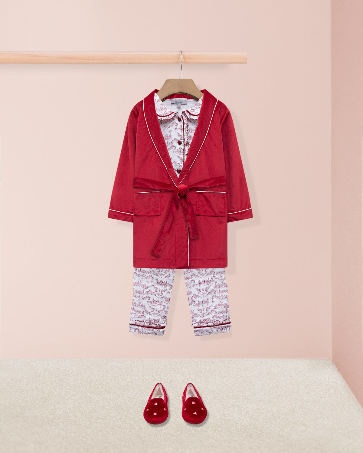 Red robe and lougewear set with matching shoes on a pink background