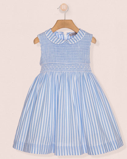 Blue and white striped dress on a hanger against a beige background