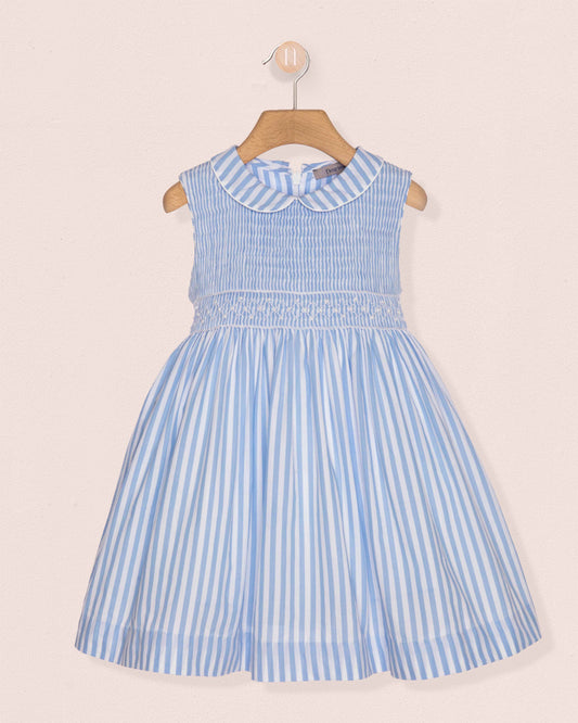 Blue and white striped dress on a hanger against a beige background