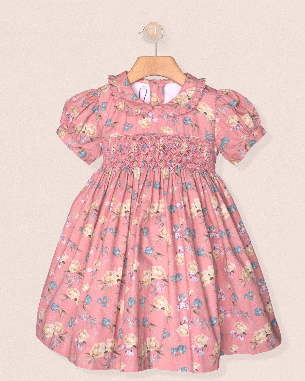Pink floral dress on a beige background