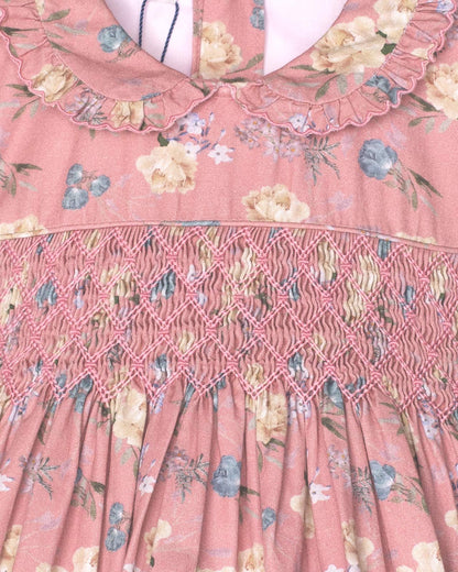 Close-up of a pink floral dress with intricate lace detailing.