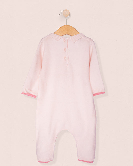 Back of baby onesie with 3 buttons on a hanger, with white background