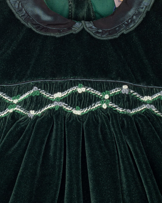 Close-up of a green velvet garment with intricate beadwork