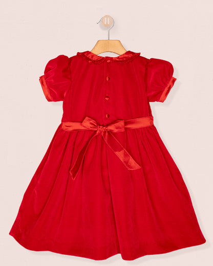 Red dress with a bow sash on a beige background back view