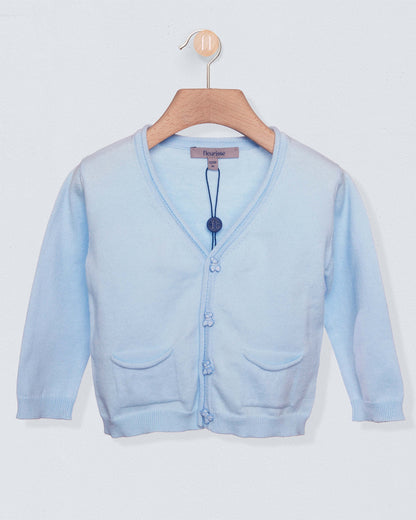Light blue cardigan sweater with bear buttons on a light grey background