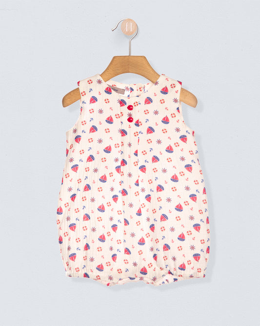 Baby romper with patterns on a hanger against a light gray background