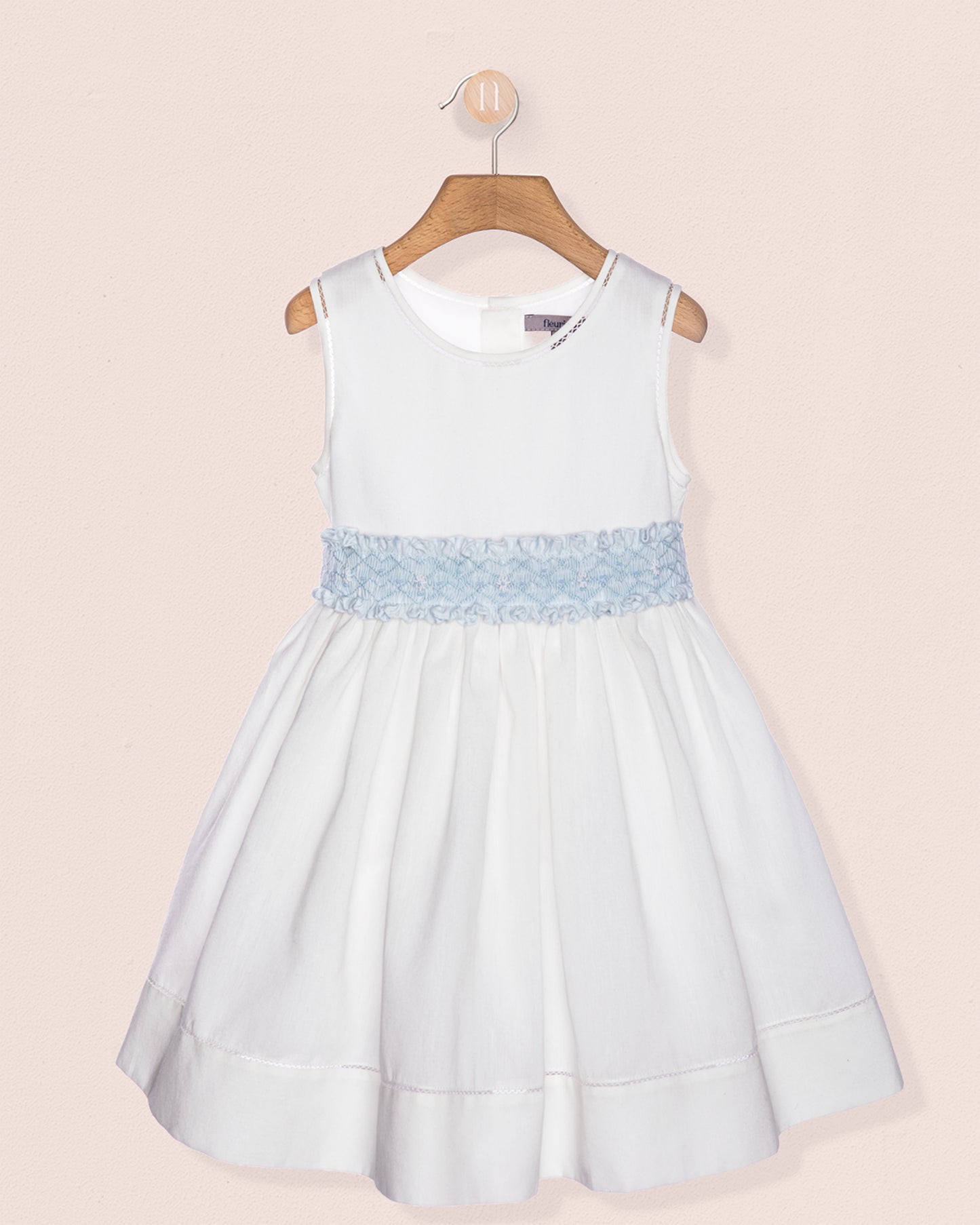 Light blue dress with lace detail on a beige background