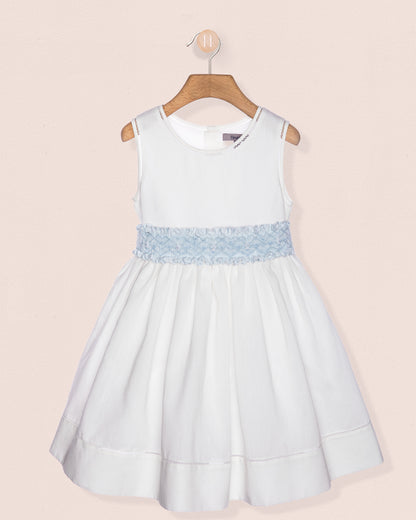 Light blue dress with lace detail on a beige background