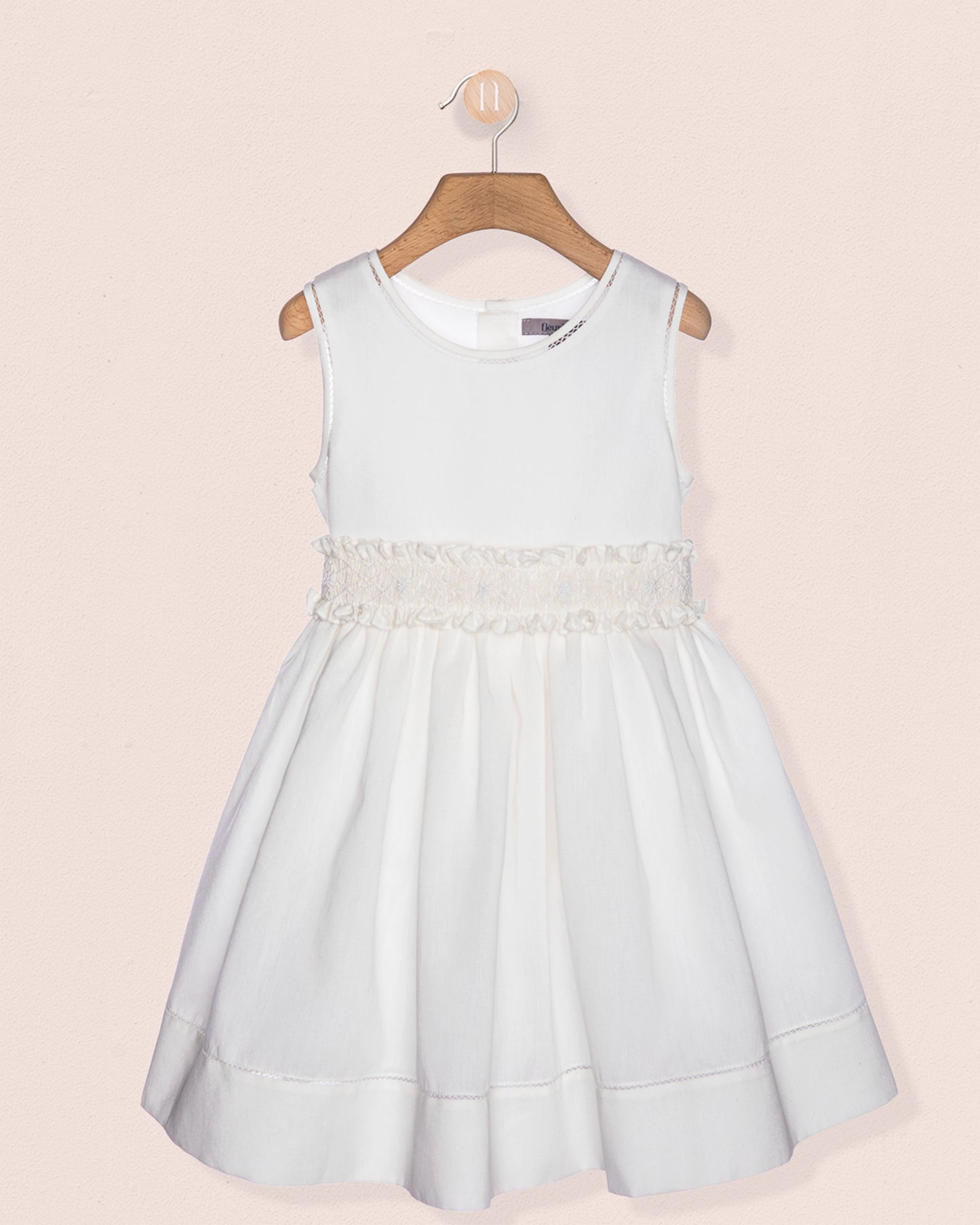 Light blue dress with lace details on a pink background