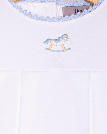 White baby outfit with embroidered unicorn design and 'fleury' label.