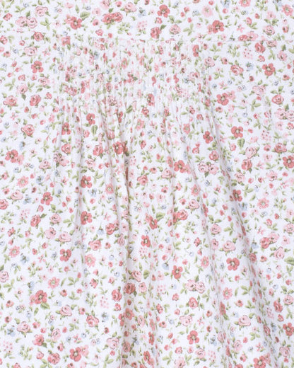 Floral patterned fabric with small pink flowers on a white background