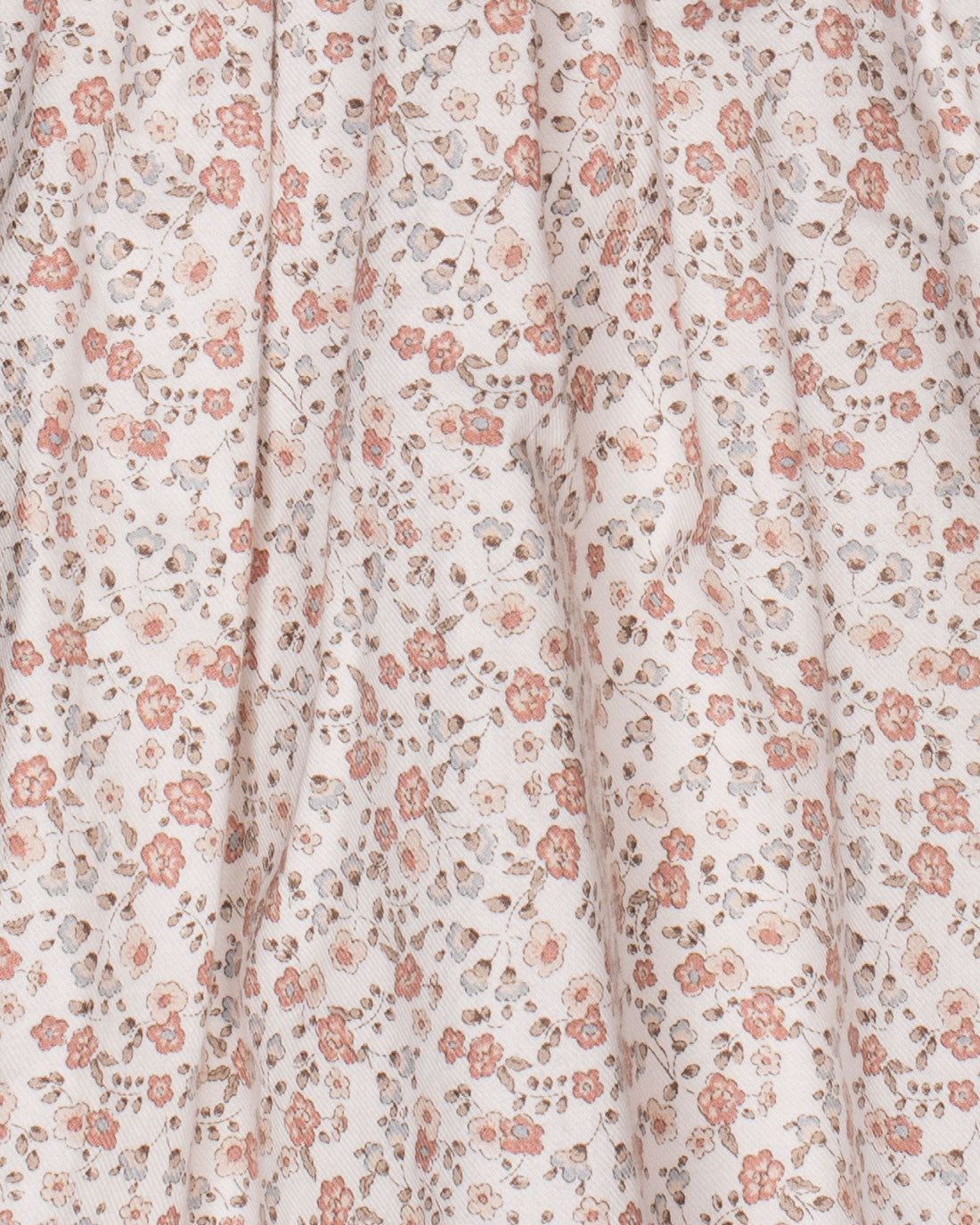 Close-up of the dress fabric, featuring a soft twill texture with a delicate French floral print in shades of pink, mauve, and green.