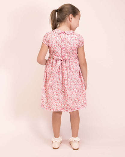 Girl wearing Violette French Blossom Pink Smocked Dress with Cream Shoes and Ruffle Socks showing the back of the dress 