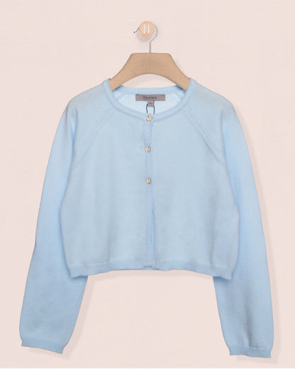 Light blue cardigan on a hanger against a beige background