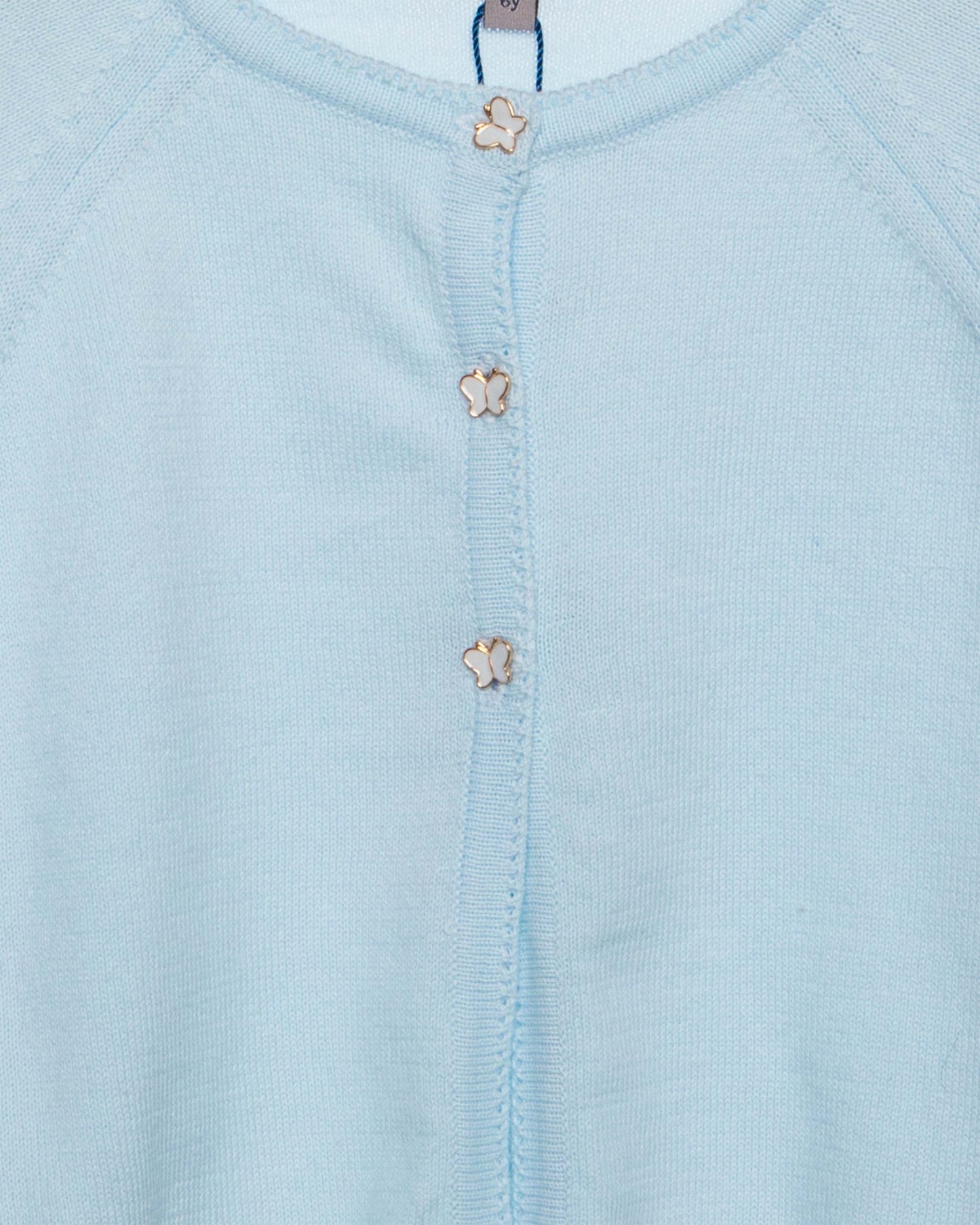 Light blue baby outfit with floral buttons and 'fleurisse' brand label.