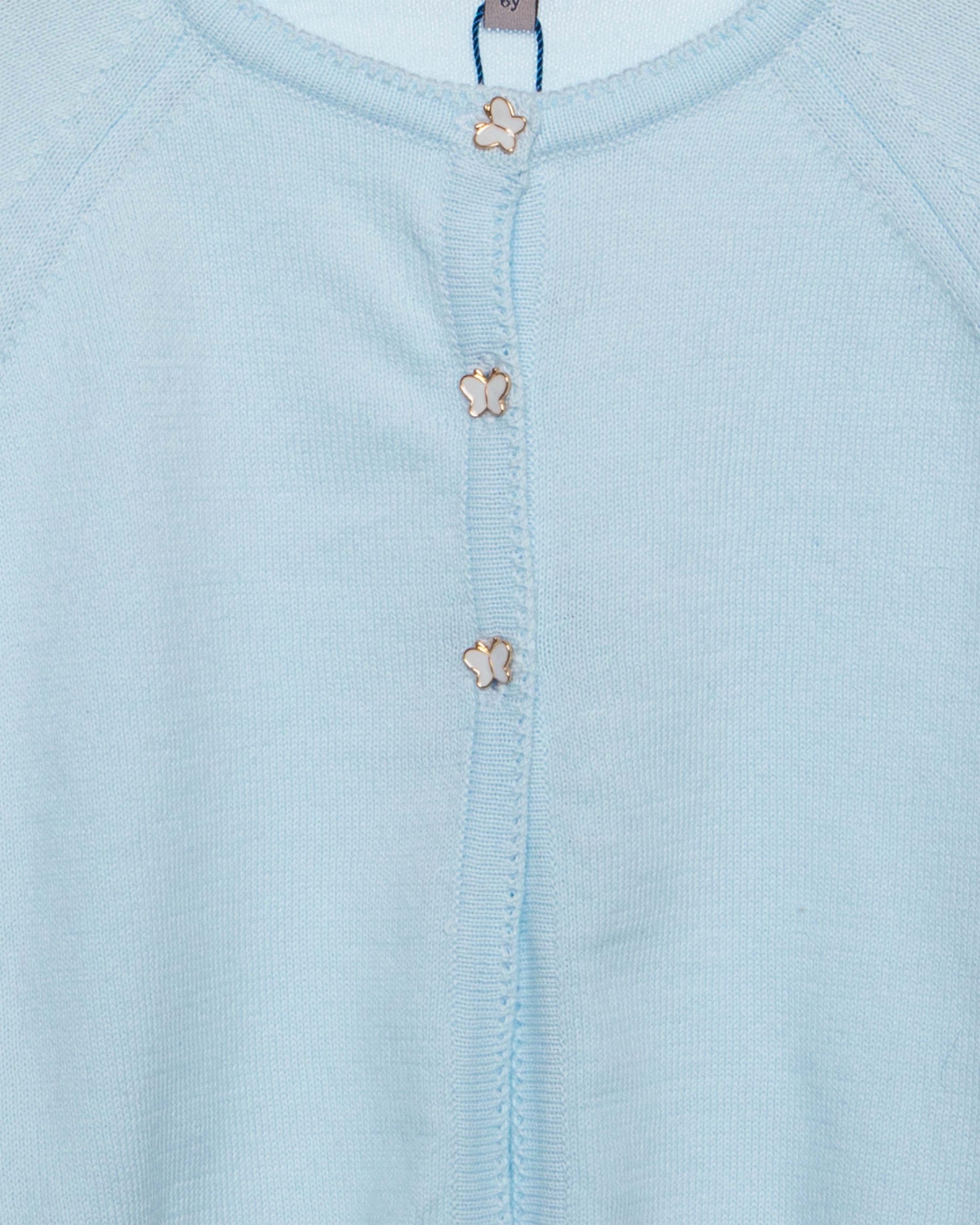 Light blue baby outfit with floral buttons and 'fleurisse' brand label.