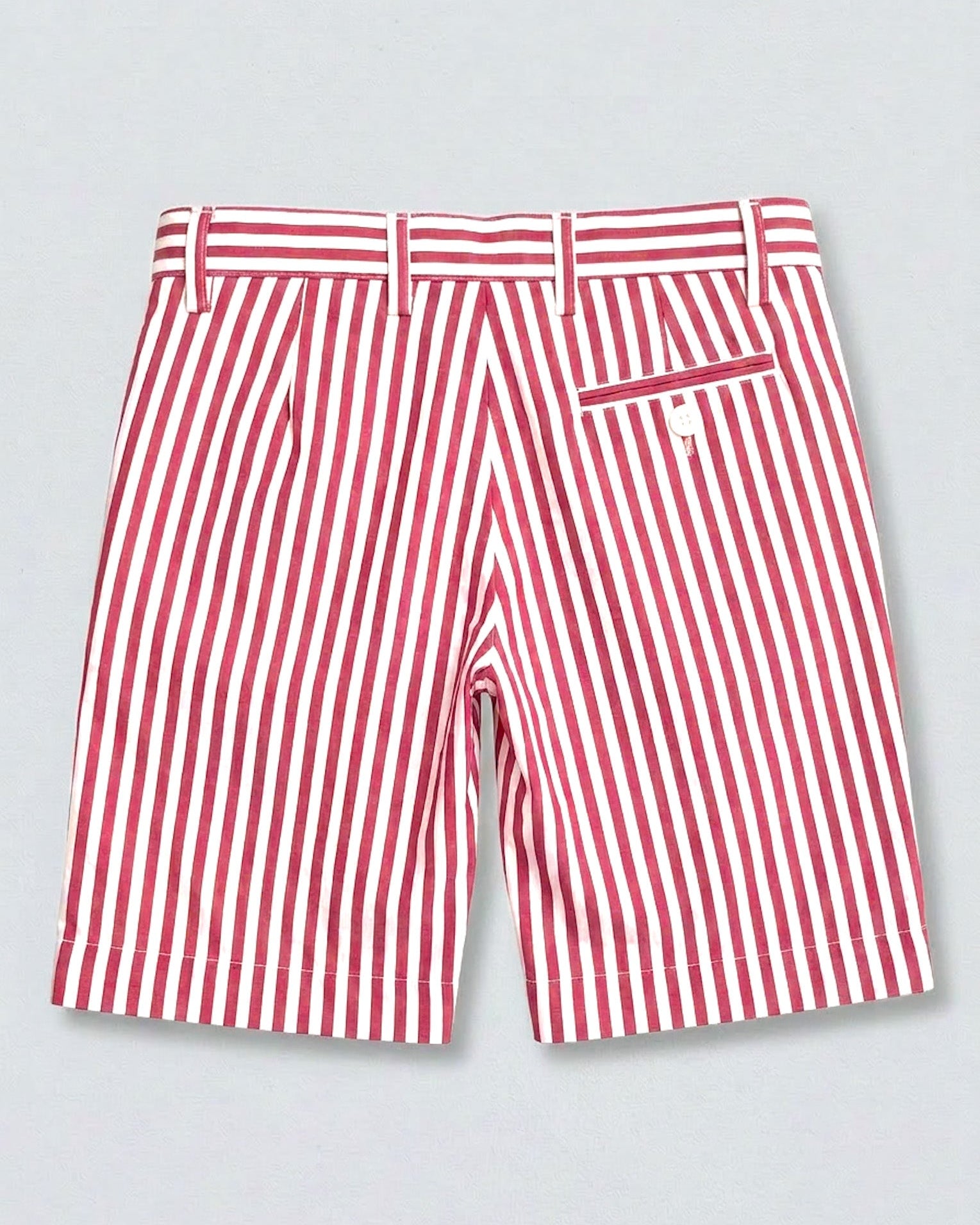 back of red and white striped shorts with 1 pocket and white button on right side, 4 visible belt loops, against a grey background.