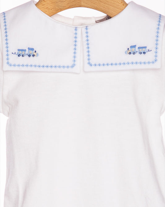 White shirt with blue embroidered details on a hanger