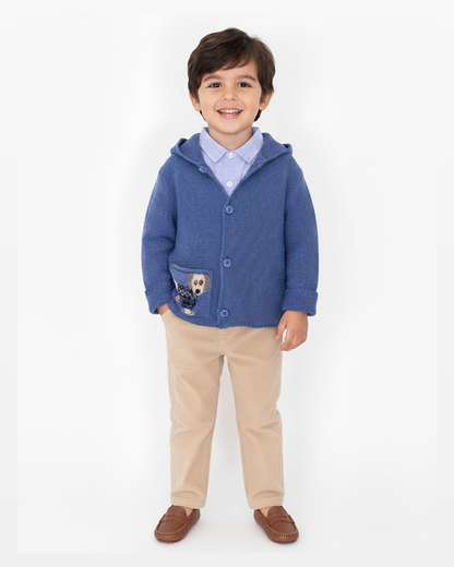 Child wearing a blue hoodie with a dog design on a white background