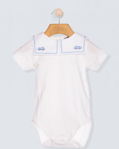 White baby bodysuit with blue trim on a wooden hanger against a light gray background