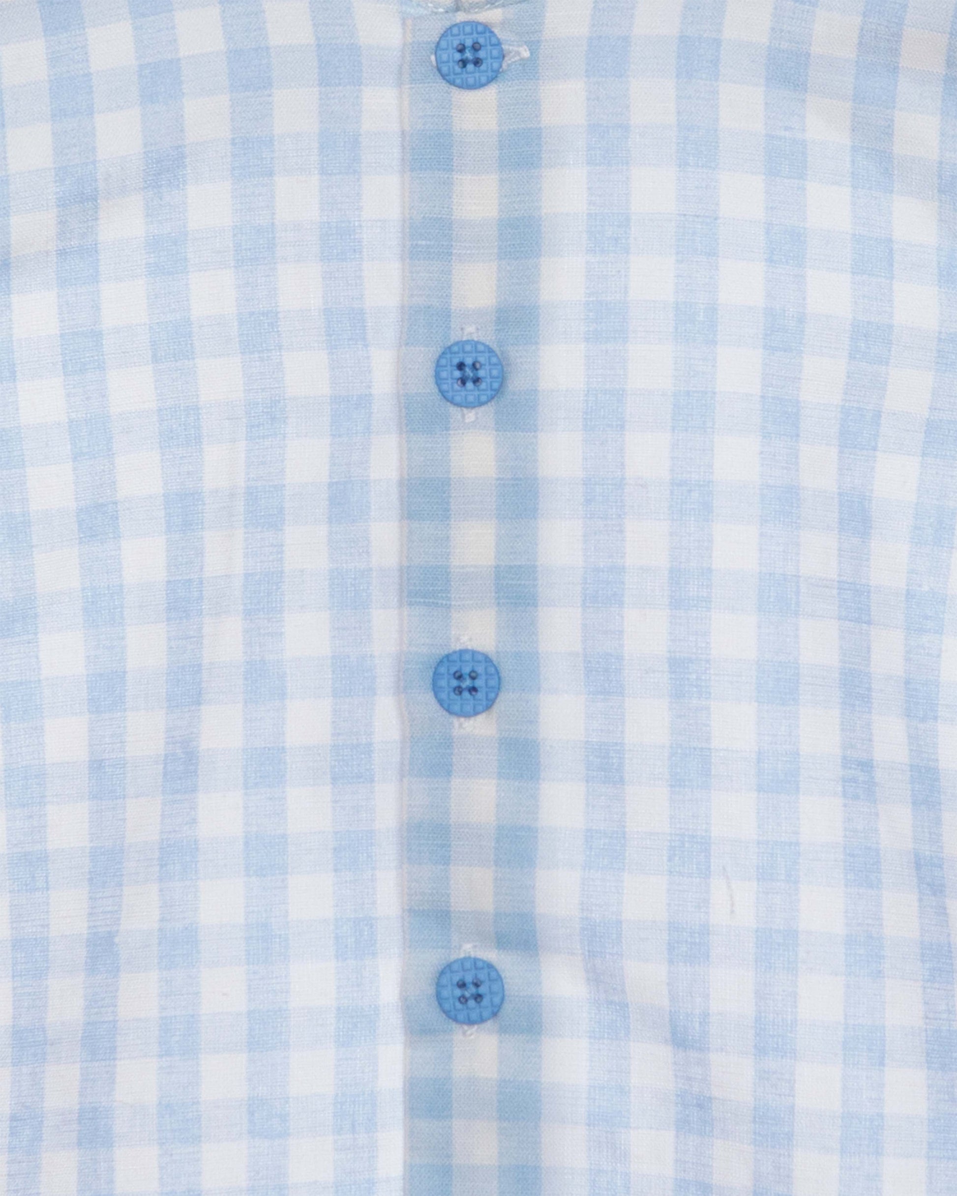 Close-up of a blue and white checkered shirt with buttons.