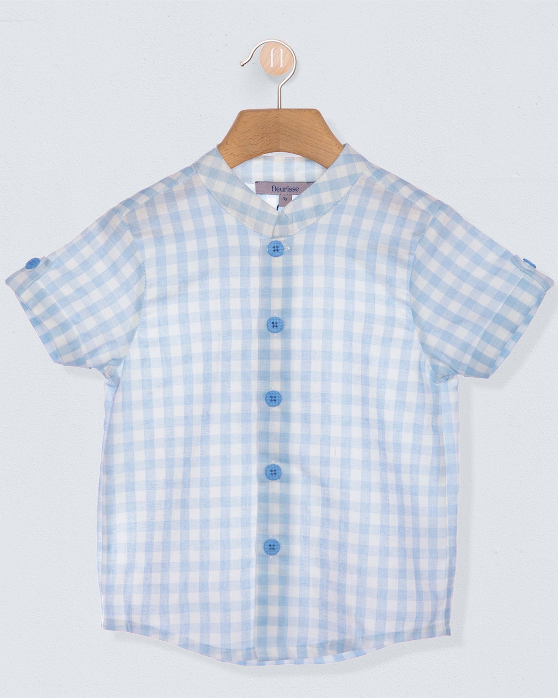 Blue and white checkered shirt on a hanger against a light gray background