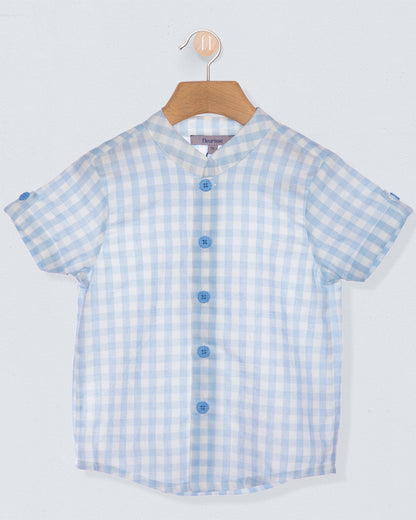 Blue and white checkered shirt on a hanger against a light gray background