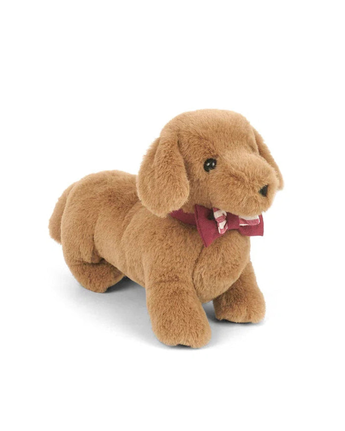 Plush toy dog with a red bow tie on a white background