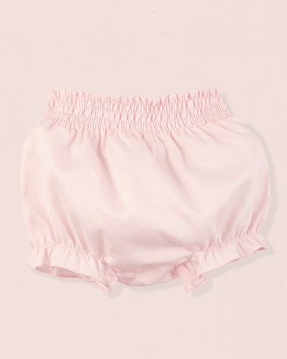 Pink baby bloomers on a light pink background