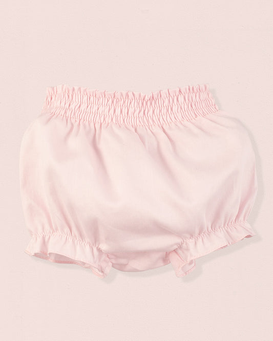 Pink baby bloomers on a light pink background