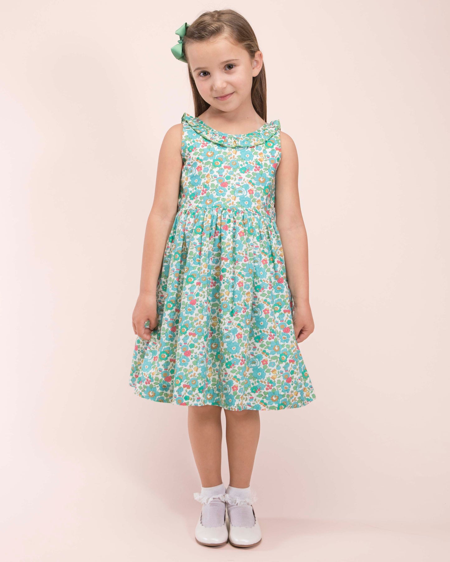 Girl wearing Ella Liberty Betsy Mint Dress with a matching mint hairbow showing the front of the dress 