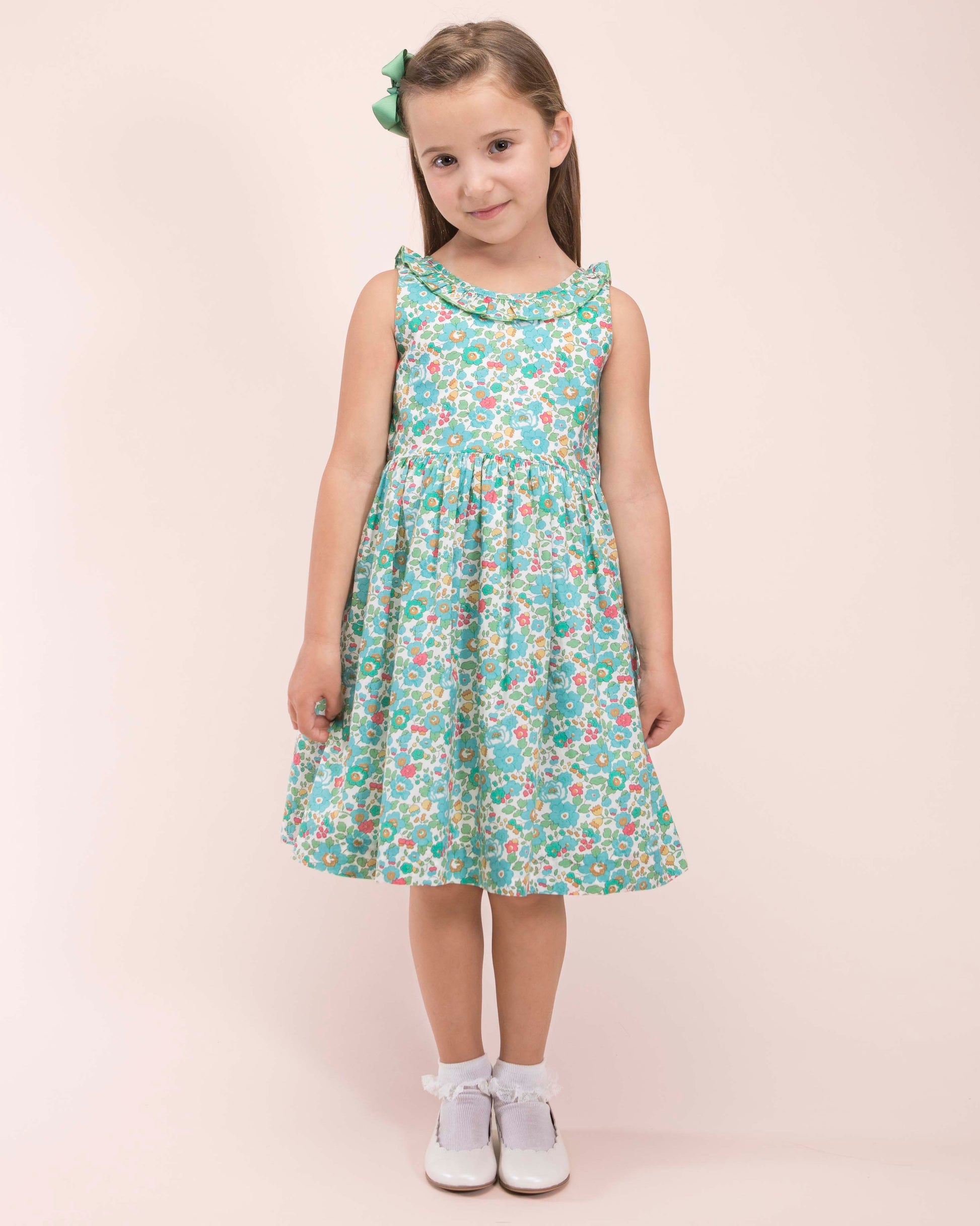 Girl wearing Ella Liberty Betsy Mint Dress with a matching mint hairbow showing the front of the dress 