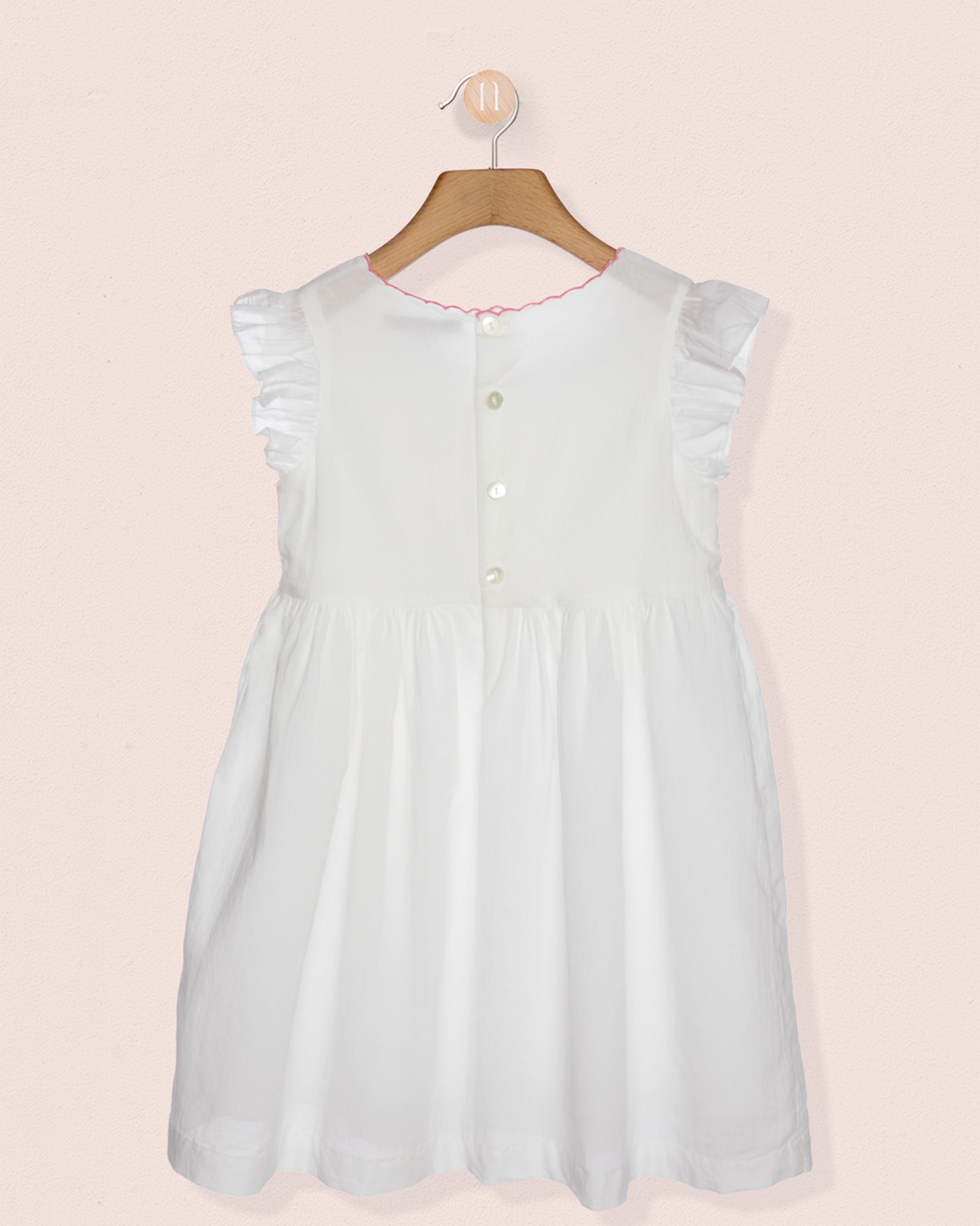 Light blue dress on a hanger against a pink background