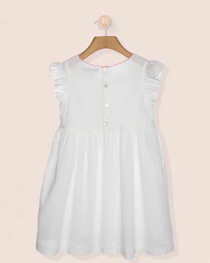 Light blue dress on a hanger against a pink background