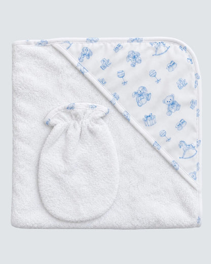 A white hooded baby towel with a matching drawstring baby mitt, featuring a blue teddy bear pattern on the hood, laid flat on a light blue background.