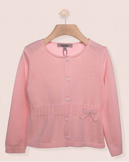 Pink cardigan on a hanger against a light pink background