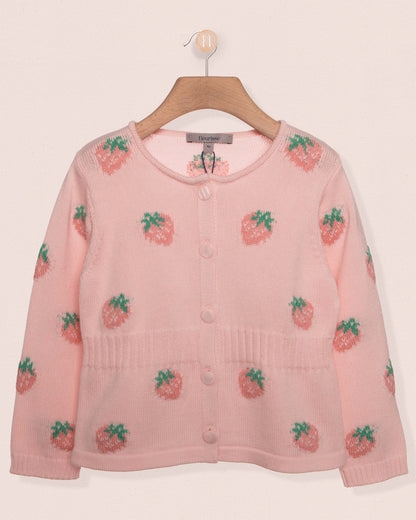Pink cardigan with strawberry pattern on a hanger against a light background