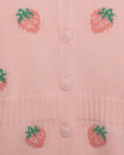 Pink cardigan with strawberry patterns and buttons on a light pink background