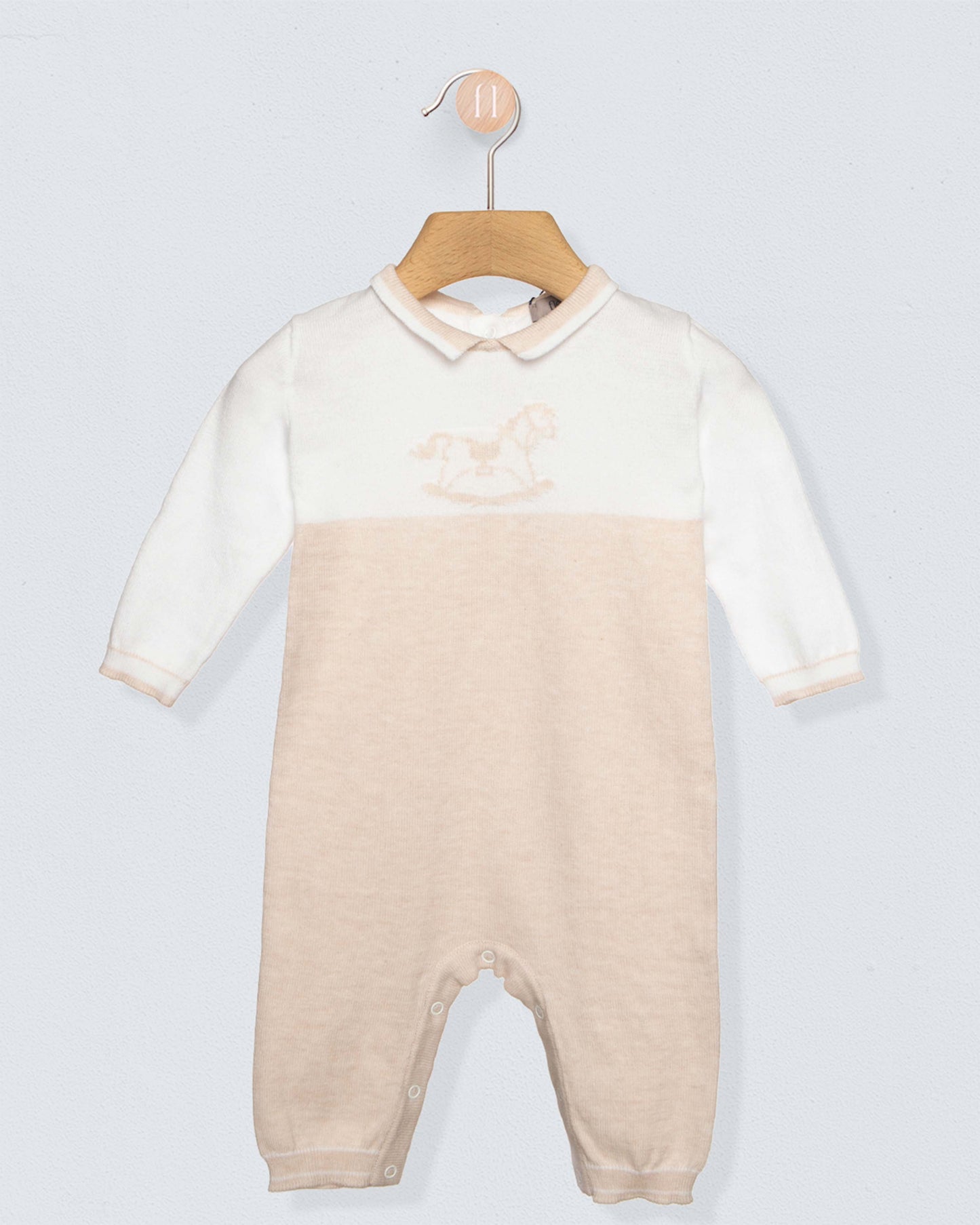 Baby onesie with a gradient design on a hanger against a light gray background