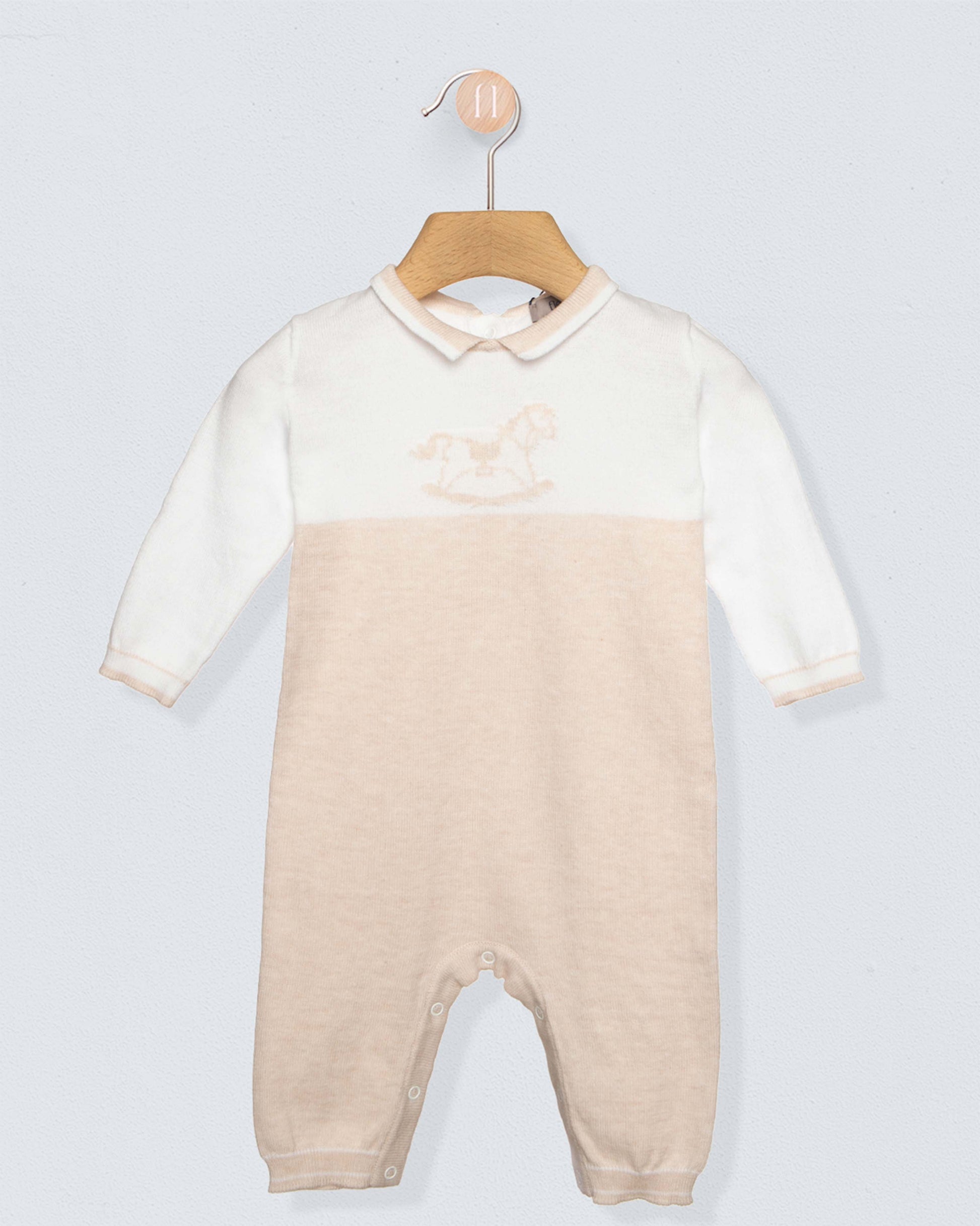 Baby onesie with a gradient design on a hanger against a light gray background