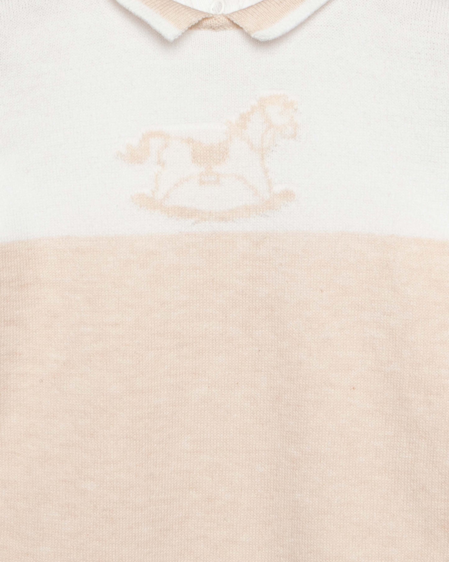 Baby outfit with white collar and beige bodice on a light background