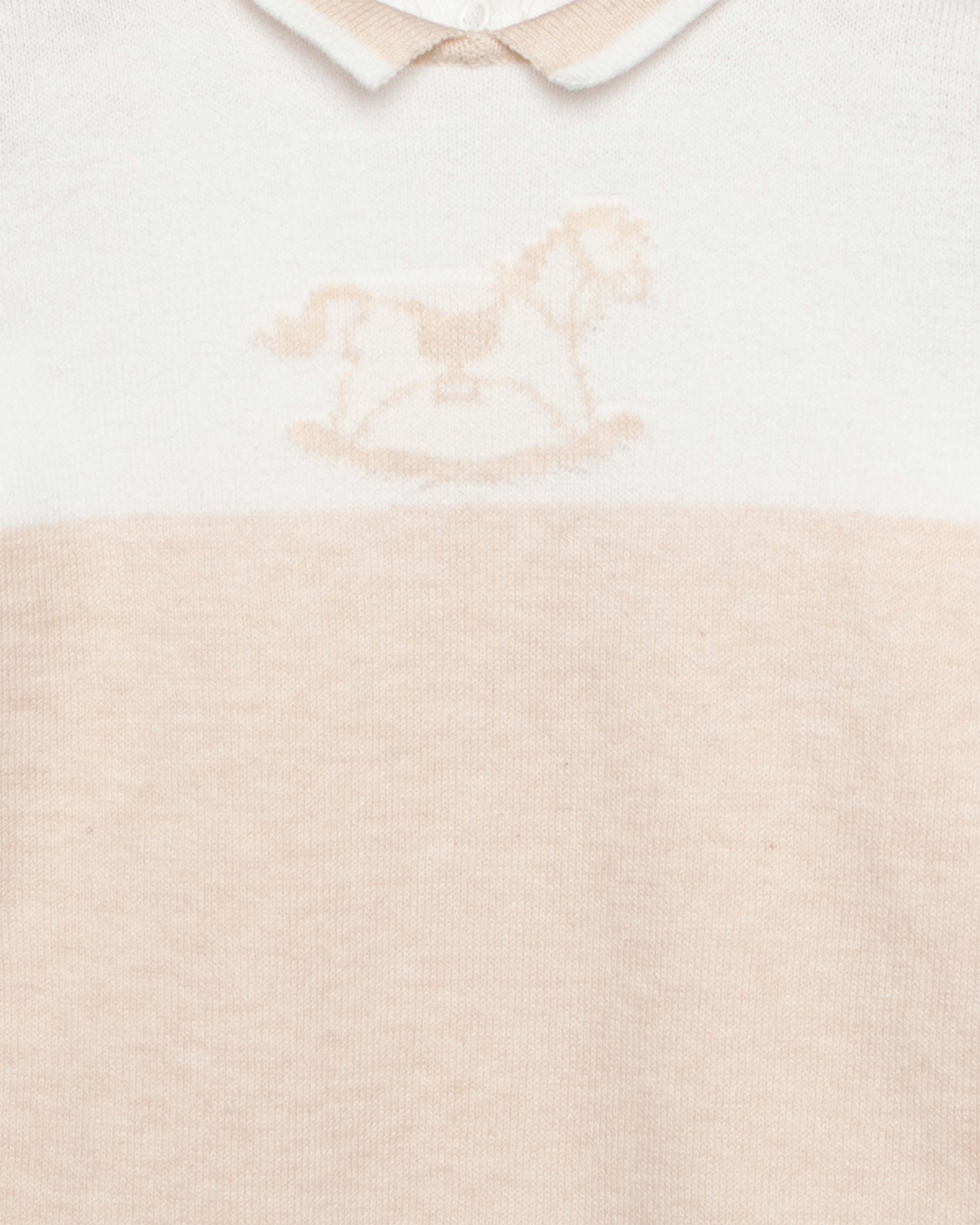 Baby outfit with white collar and beige bodice on a light background