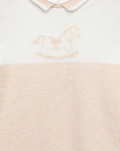 Baby outfit with white collar and beige bodice on a light background