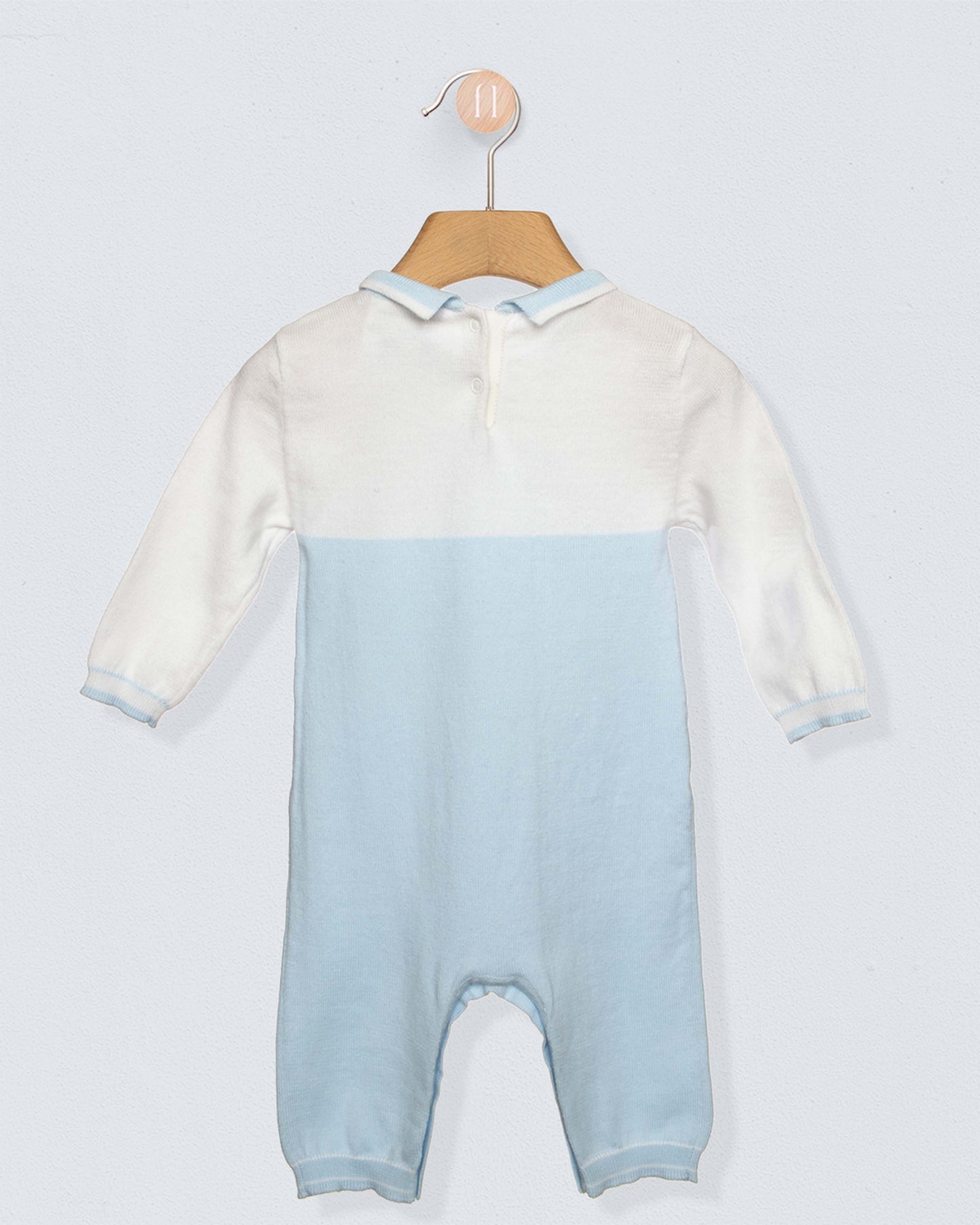 Back of Long sleeved romper with white on top, light blue from the torso through the legs, with a blue collar and a horse design on chest, against a grey background