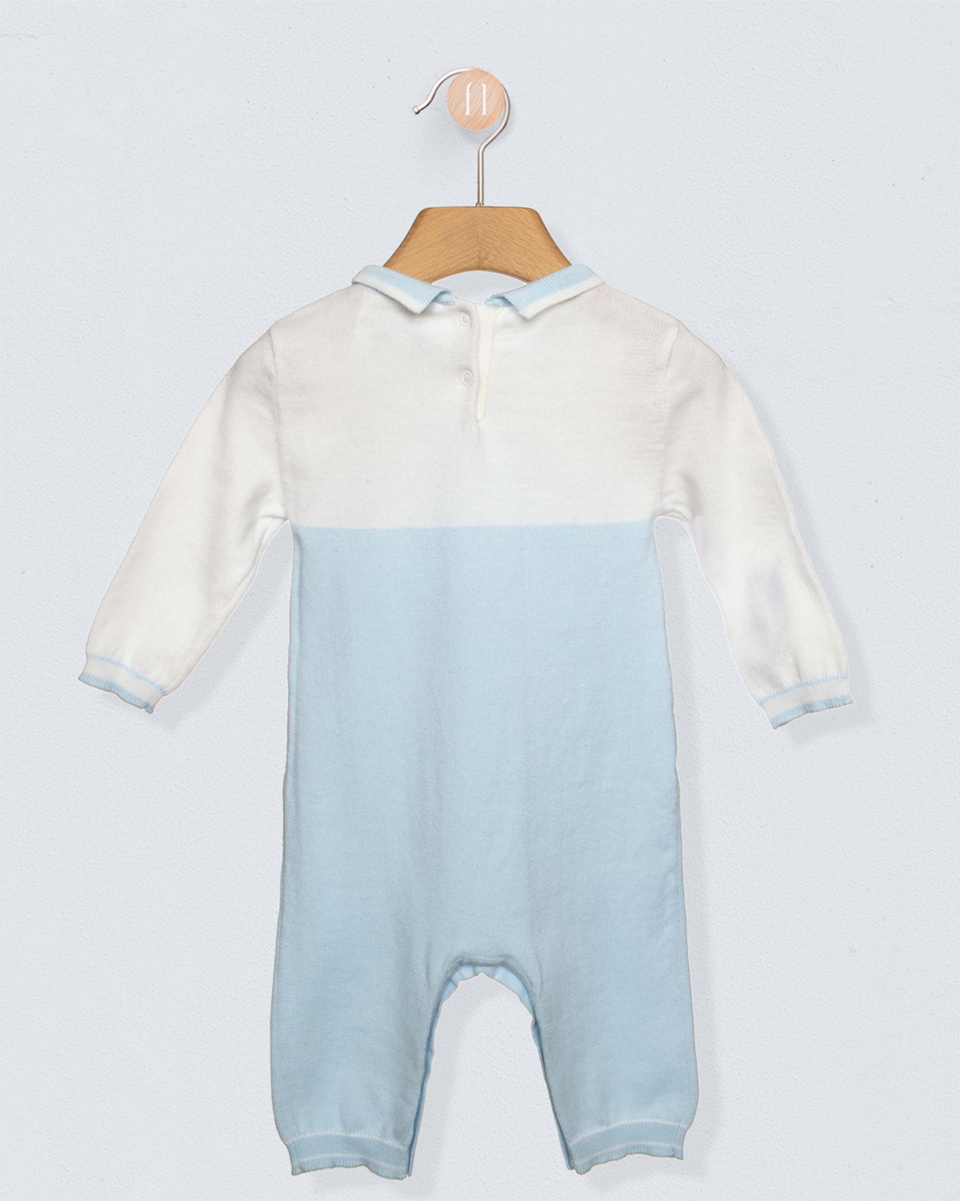 Back of Long sleeved romper with white on top, light blue from the torso through the legs, with a blue collar and a horse design on chest, against a grey background