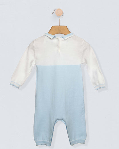 Back of Long sleeved romper with white on top, light blue from the torso through the legs, with a blue collar and a horse design on chest, against a grey background