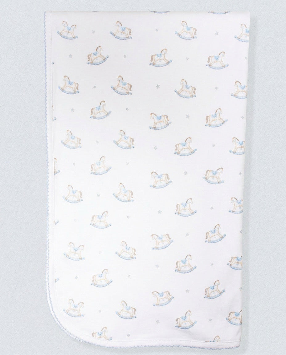white baby blanket with blue and brown rocking horses.